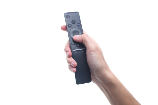 istock Hand holds tv remote isolated on white background 1131208435