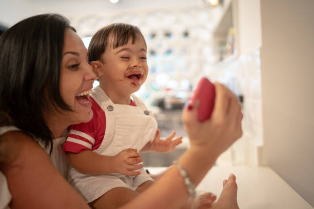 Mother and Down Syndrome son taking a selfie after eating chocolate