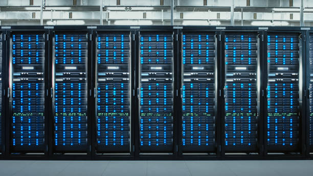 istock Camera Slide-Trough Shot of a Working Data Center With Rows of Rack Servers. Led Lights Blinking and Computers are Working. 1131208543