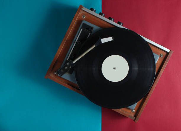 istock Retro vinyl record player on red-blue background. Top view 1131212804