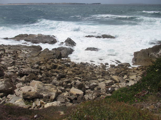 istock cliff edge with ocean and ocean waves and clouds 1131214629