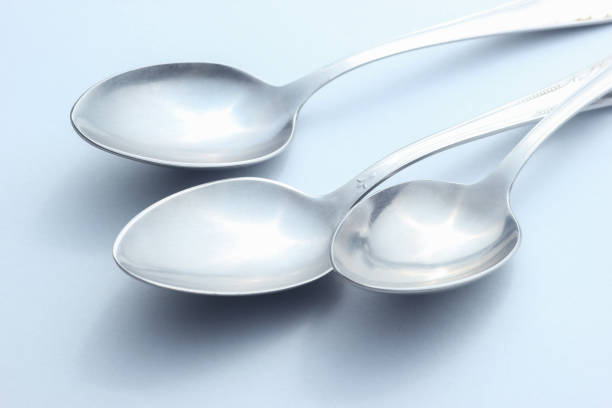 Spoon and fork on tablecloth.