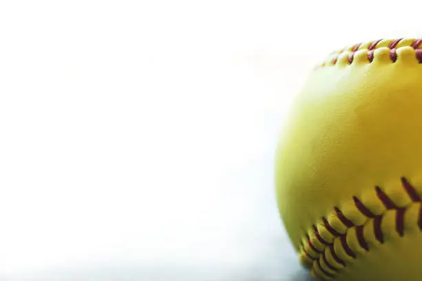 Fastpitch softball on white background.