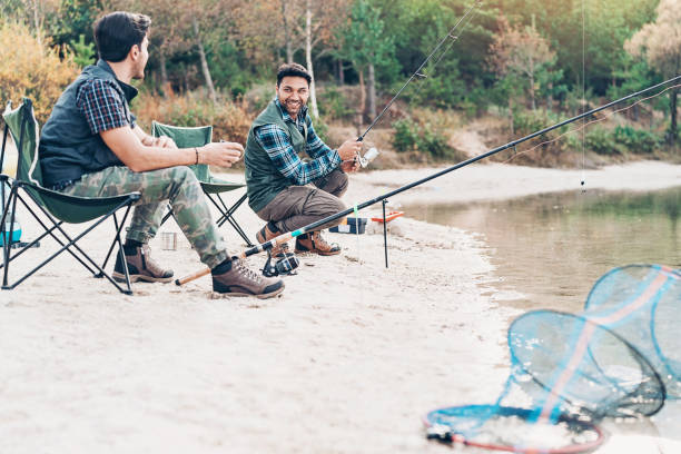 istock Two young men fishing together 1131216427