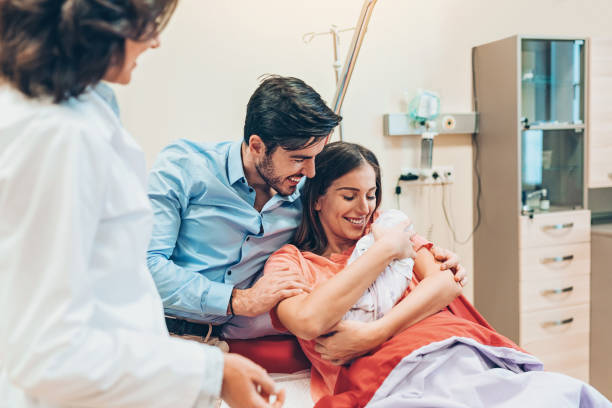 couple with newborn baby in the hospital