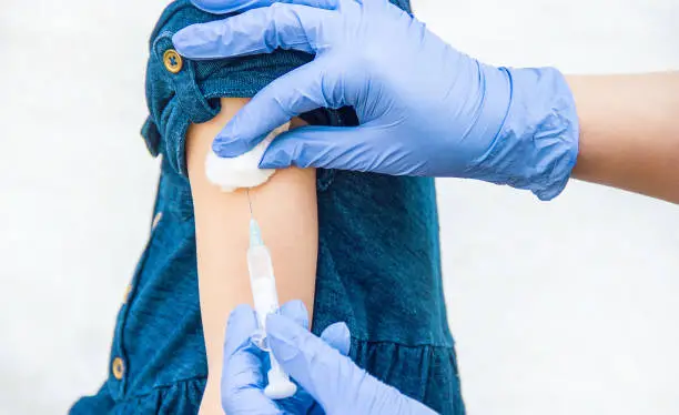 Photo of vaccination of children. An injection. Selective focus.