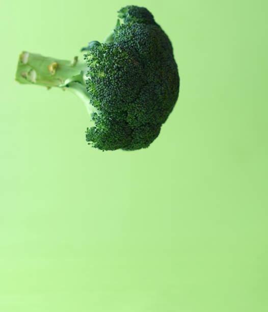 istock Broccoli in the air on a green background 1131220329