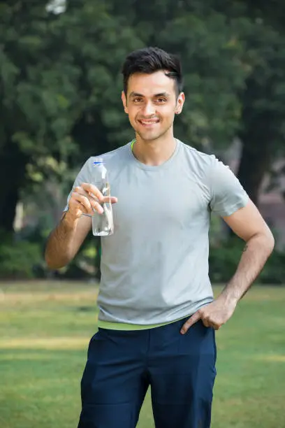 Photo of a young man drinking water - Stock image Photo of a young man drinking water - Stock image