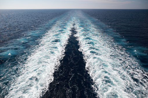 Trail of beautiful and clear water from cruise ship in Caribbean Sea in summer time
