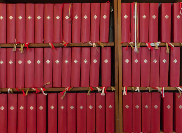 Close up of gold leaf titling on the spine of an antique book of songs.