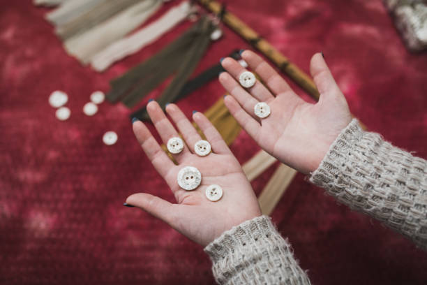 Tailor choosing buttons and zippers, close-up