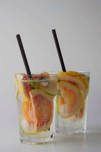 istock Traditional summer drink lemonade. With strawberries, oranges, lemon, lime, and grapefruit. Vertical iamge, toned. 1131224135