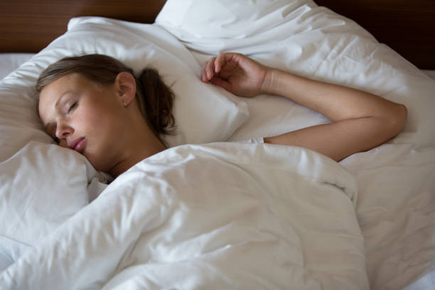 istock Beautiful young woman sleeping in bed 1131225977
