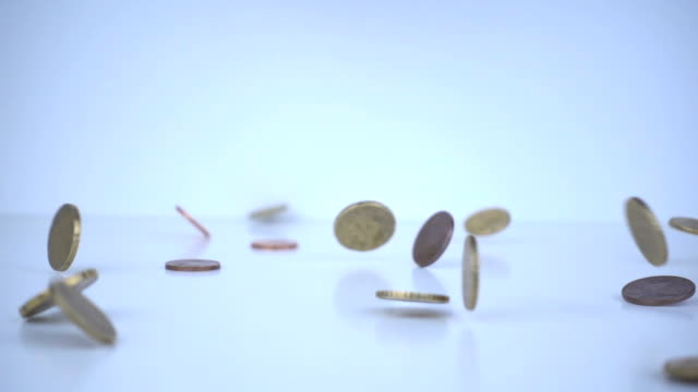 Euro coins falling on the floor in slow motion.