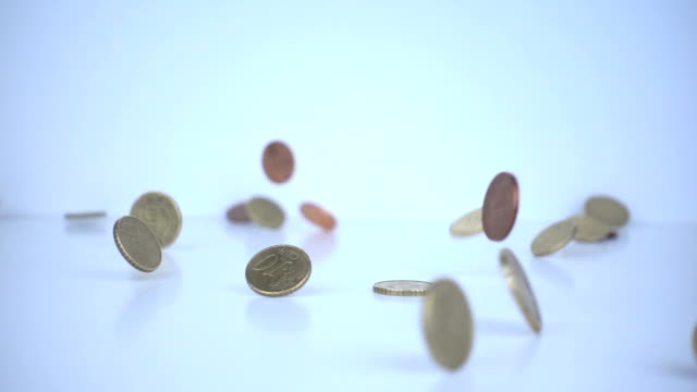 Euro coins falling on the floor in slow motion.