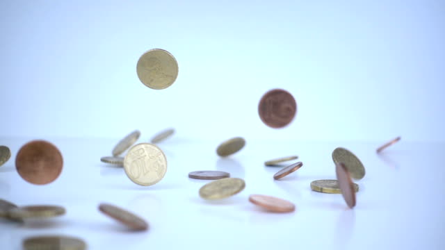 Euro coins falling on the floor in slow motion.