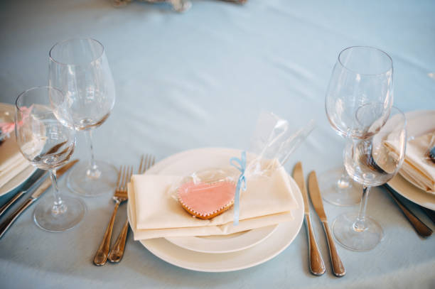 istock White plates on blue tablecloth, pink and blue heart form cookies on plates 1131228483