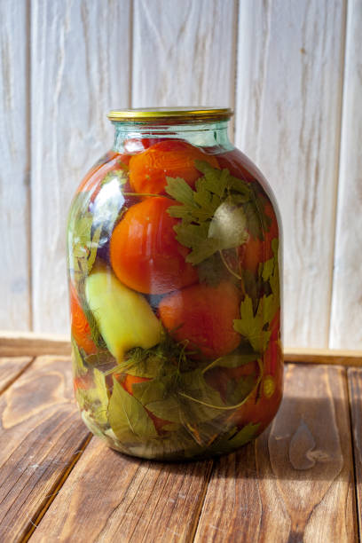 istock Canned tomatoes and cucumbers with fresh vegetables 1131230072