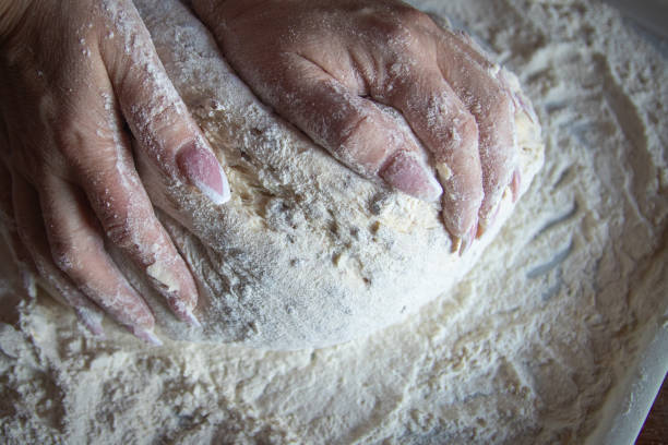 istock Woman's hands with manicured nails work with dough in the kitchen 1131231495