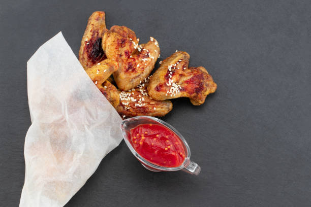 istock Baked chicken wings on dark background with copy space. Top view 1131232779