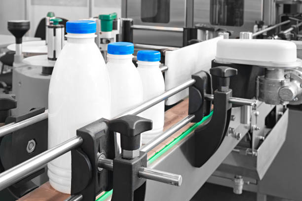 istock Plastic bottles on conveyor belt ready for pouring milk 1131233163