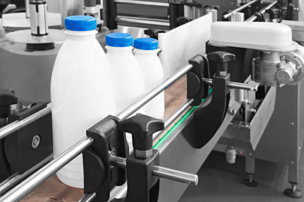 istock Plastic bottles on conveyor belt ready for pouring milk 1131233179