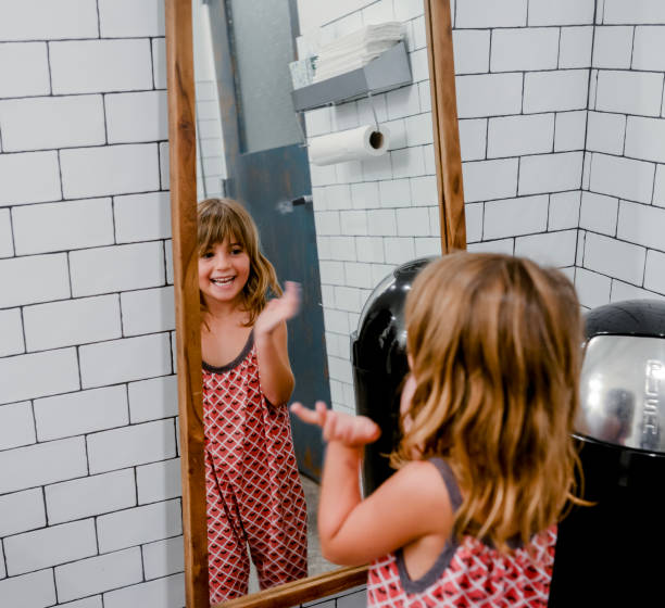 istock Little girl makes faces in a bathroom 1131234856
