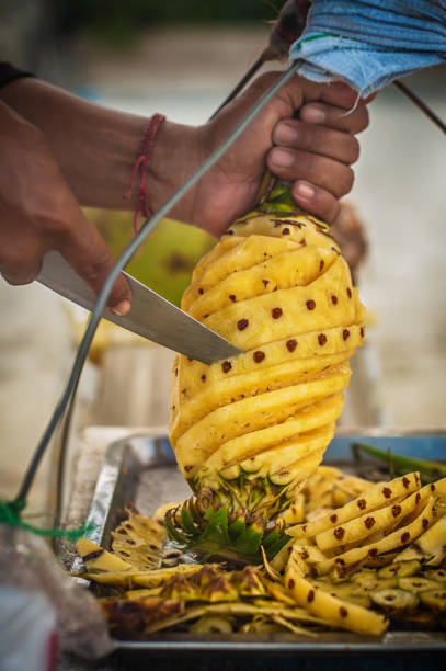 istock Local man preparing fresh fruit on a tropical beach 1131235997
