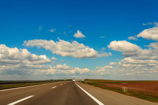 istock Abstract speed motion on highway background image through countryside with beautiful clouds 1131237463