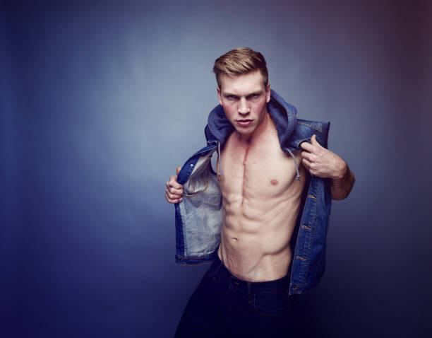 istock Handsome man wearing a vest and showing off his abs 1131237978
