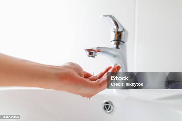 Hand Under Faucet With Low Pressure Water Stream Stock Photo - Download Image Now - Physical Pressure, Water, Low