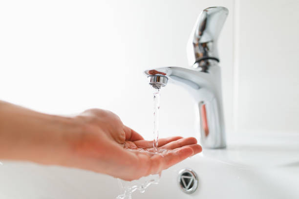 istock hand under faucet with water stream 1131238230