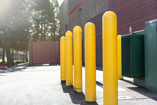 Yellow bollards for parking and restriction in a parking lot