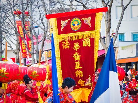 Paris, France - February 17, 2019. Last day of the chinese new year celebration festival in street. People dragon lion dancing show colorful costumes. 200 thousands, multi ethnic asian man woman. Year of pig