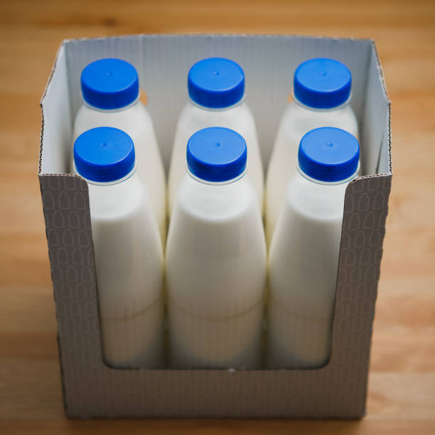 istock milk bottles in cardboard box on wooden table 1131240681