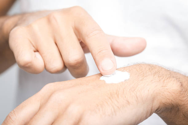 istock Man applying hand cream on white background, closeup 1131243356
