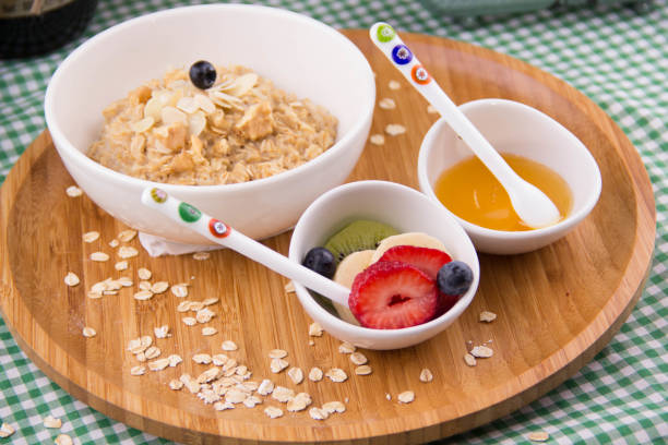 fresh berries, yogurt and homemade granola for breakfast, honey, fruit stock photo