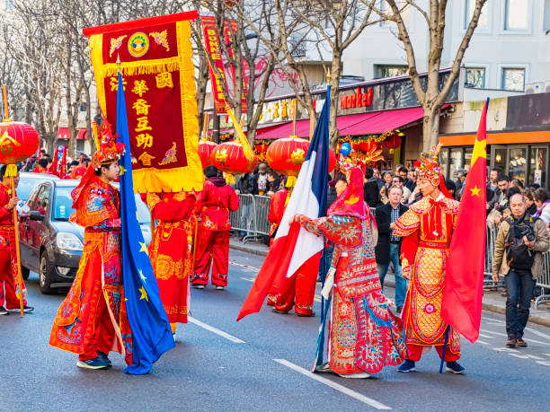 Paris, France - February 17, 2019. Last day of the chinese new year celebration festival in street. People show walking with colorful costumes and decorations. 200 thousands, multi ethnic asian man woman. Year of pig