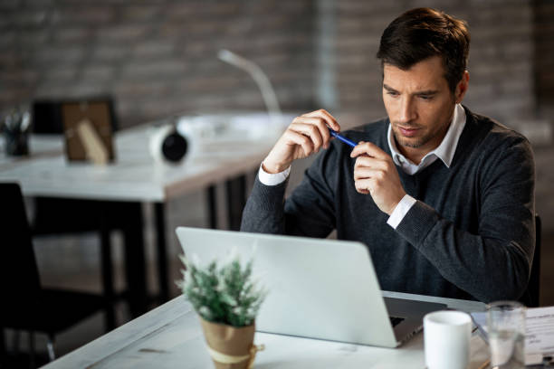 istock Concentrated businessman reading something on a computer while working in the office. 1131253622