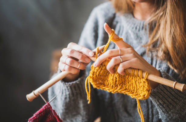 istock Close up on woman's hands knitting 1131260117