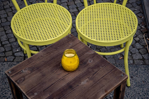 istock Yellow green wicker chairs and candle on table. 1131261570