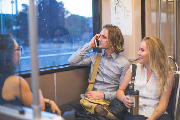 business colleagues riding on public transit together - bus riding public transportation businessman imagens e fotografias de stock