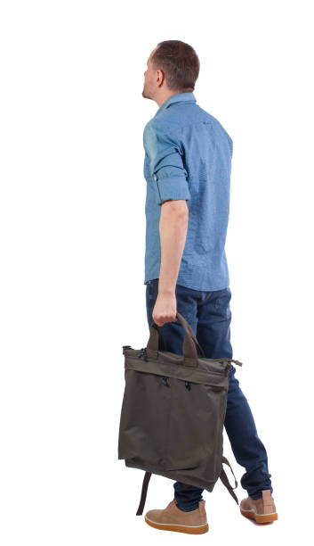 istock Back view of a man with a green bag. 1131264816