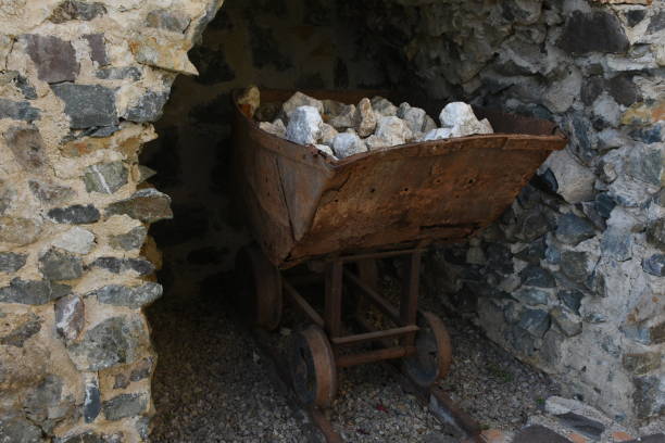 istock Old rusty wheelbarrow charged with mineral stones 1131264923