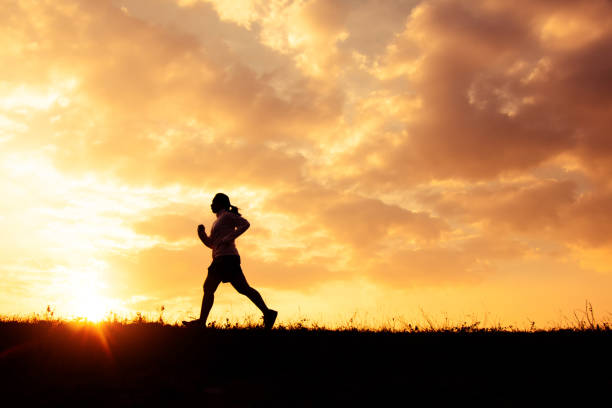 istock Woman Running On Field Against Sky During Sunset 1131265253