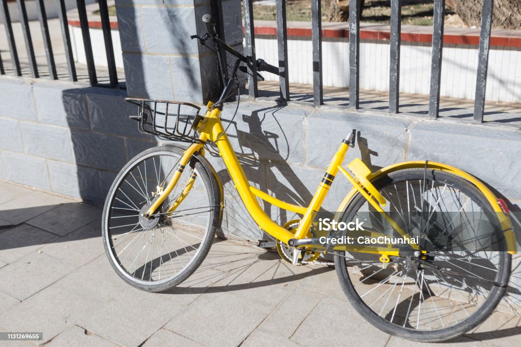 Discarded and vandalized Ofo bicycle Lhasa, Tibet, China  - January 17, 2019:Discarded and vandalized Ofo bike in the street.Ofo is the world s first and largest station-free bike sharing platform Bicycle Stock Photo