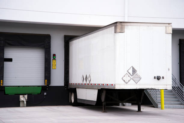 istock Semi trailer for big rig semi truck loading commercial cargo at warehouse dock with thermally insulated gate 1131269657