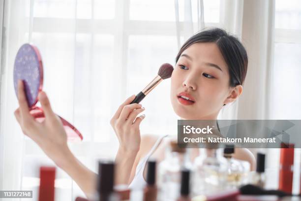 Young Beautiful Asian Woman Applying Cosmetics Make Up On Her Face Health Beauty Skin Care And Make Up Concept Stock Photo - Download Image Now