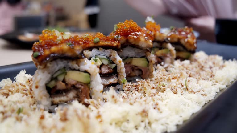 Japanese Foie Gras Roll, Rice roll of seared foie gras on the black dish. japanese food style