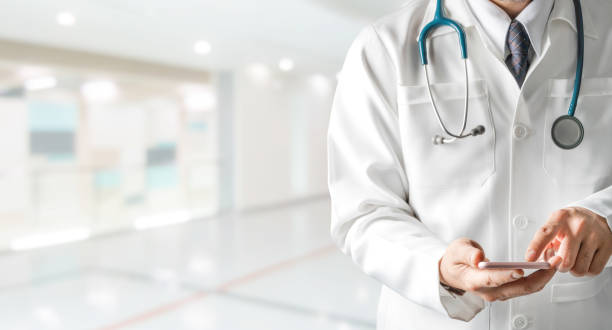 istock Male doctor using mobile phone at hospital. 1131274780